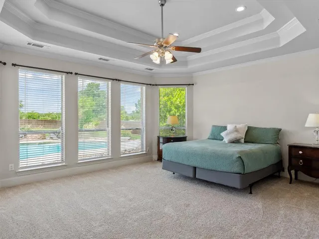 a living room with a bed mirror and a large window