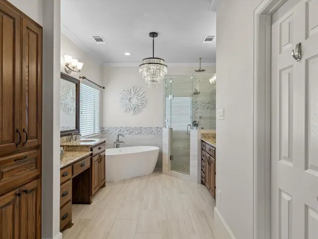 a spacious bathroom with a granite countertop sink a toilet a mirror and shower