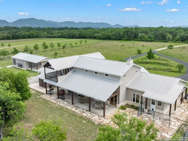 an aerial view of a house with a yard and lake view