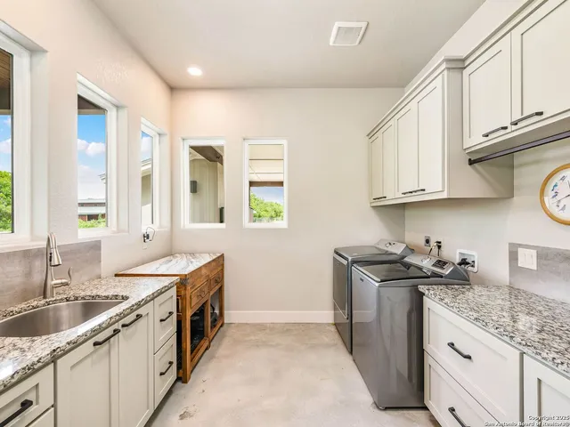 a spacious bathroom with a double vanity sink and a mirror