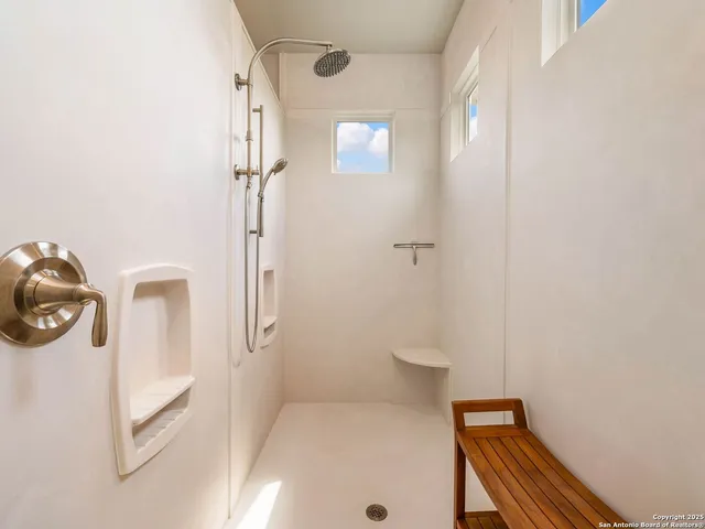 a bedroom with two beds and a chandelier