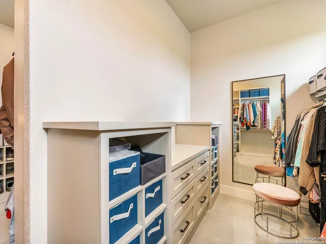 a bedroom with two beds and a chandelier