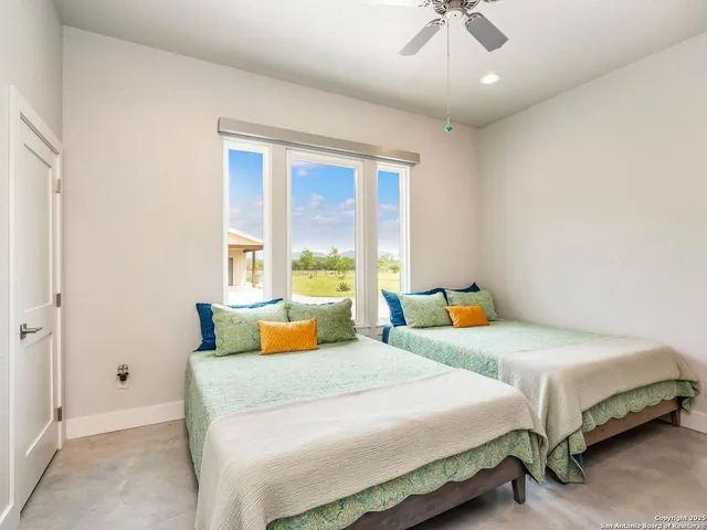 a bedroom with a large bed and a window