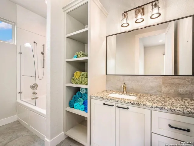 a bathroom with a sink and a mirror