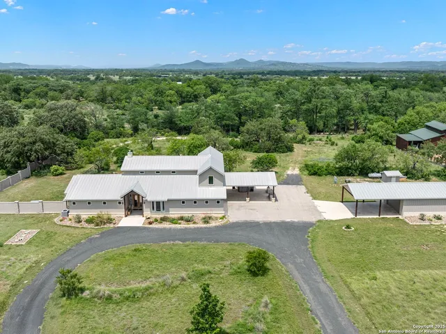 an aerial view of a house with big yard