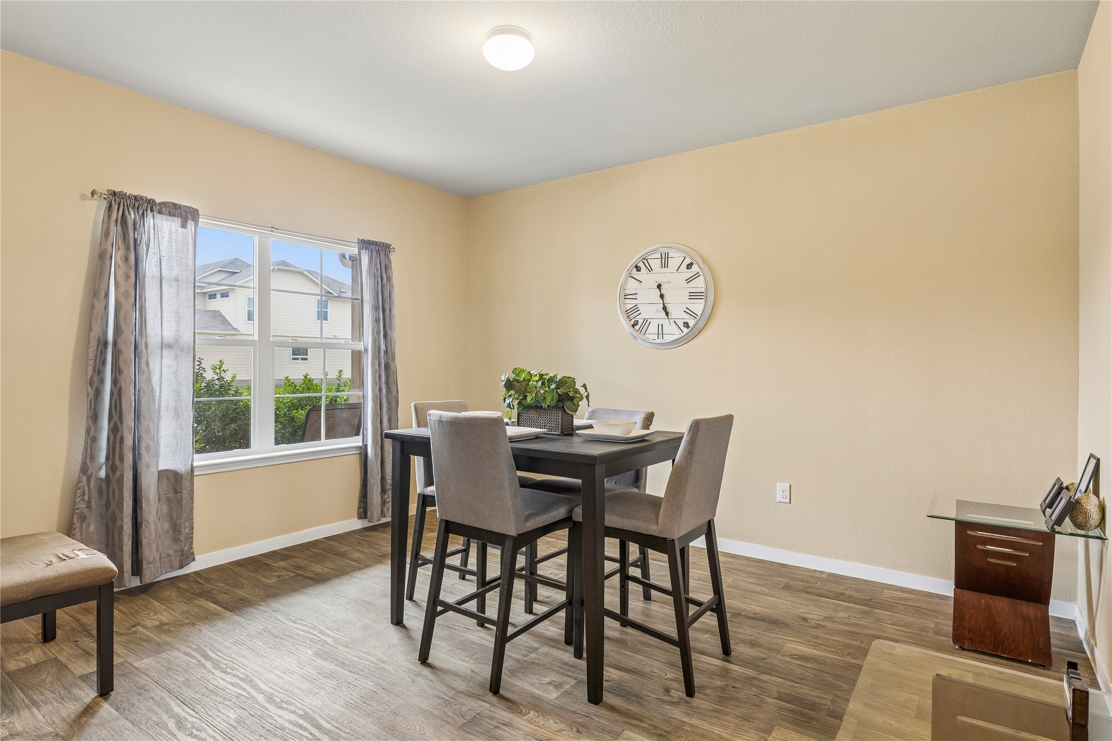 14409 Estuary Road Manor, TX 78653 - Photo 11 of 24 Spacious room featuring wood-finish flooring, light-colored wall paint, and a large window with white trim