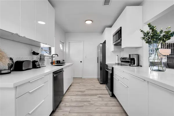 a bathroom with a sink vanity and a mirror