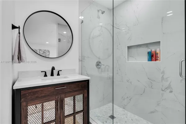 a bathroom with a sink toilet vanity and shower