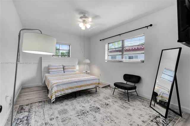 a spacious bedroom with a bed and a window