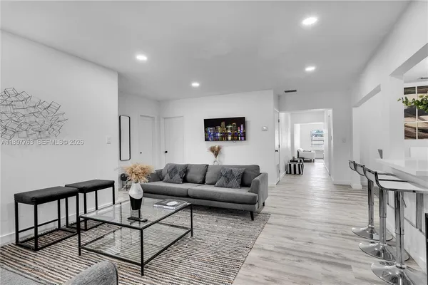 a living room with furniture and a large window