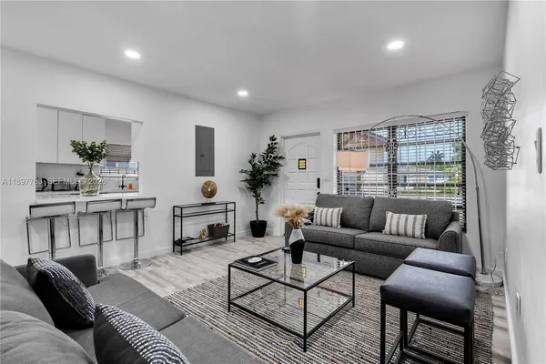 a kitchen with a sink a stove a table and chairs