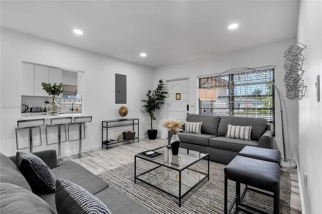 a living room with furniture and a large window