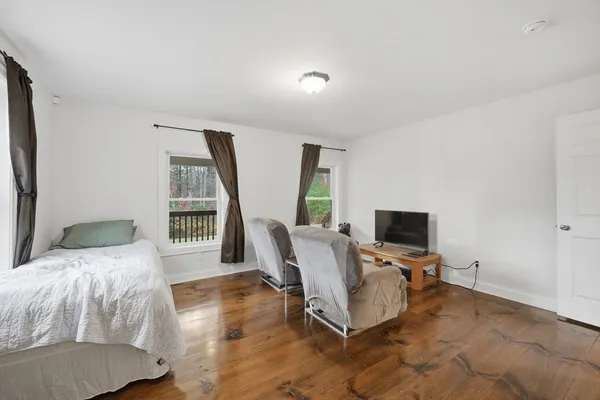a bedroom with a bed furniture and a window