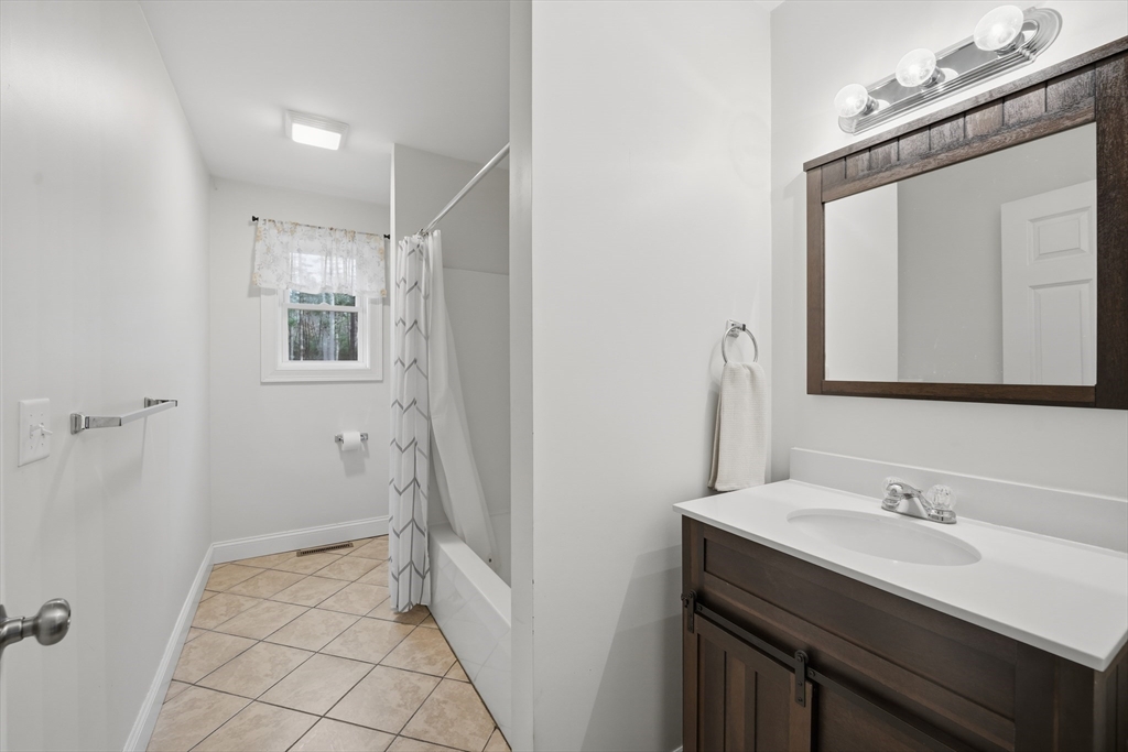 209 Osborne Road Ware, MA 01082 - Photo 16 of 32 a bathroom with a sink a vanity a mirror and shower