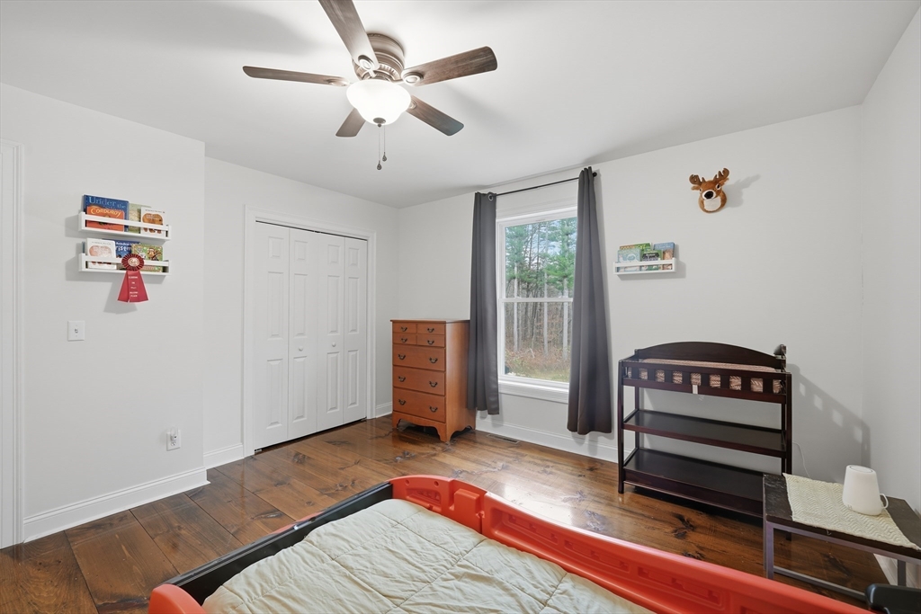 209 Osborne Road Ware, MA 01082 - Photo 22 of 32 a bedroom with a bed and a chandelier