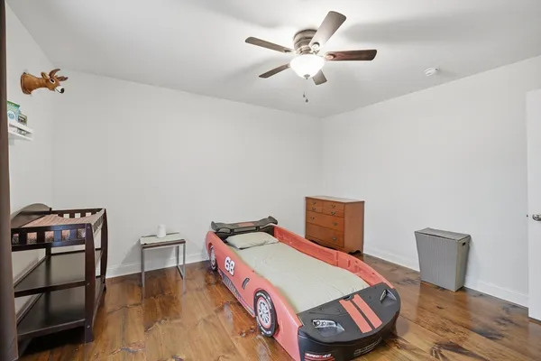 a bedroom with a bed and a chandelier