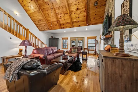 a dining room with furniture and a floor to ceiling window