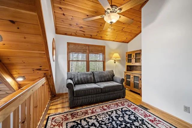 a bathroom with a granite countertop sink a mirror and a bathtub