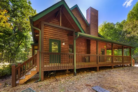 a view of a house with a wooden deck front door