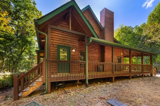 a view of a house with a wooden deck front door