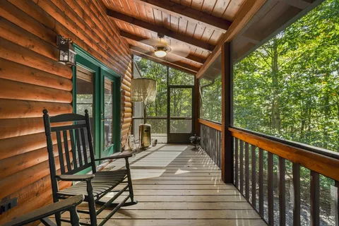 a view of a porch with wooden floor and stairs