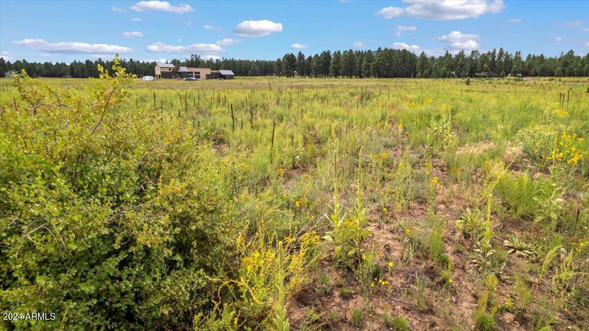 9290 Ranch At The Peaks Way, Unit 12 Flagstaff, AZ 86001 - Photo 11 of 26 a view of a lake with houses in the background