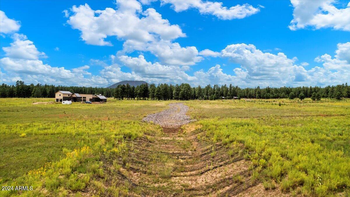9290 Ranch At The Peaks Way, Unit 12 Flagstaff, AZ 86001 - Photo 15 of 26 a view of a lake with houses in the background