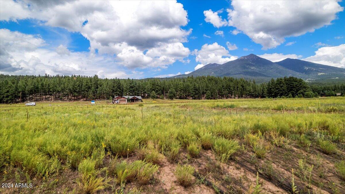 9290 Ranch At The Peaks Way, Unit 12 Flagstaff, AZ 86001 - Photo 3 of 26 a view of a lake with a yard