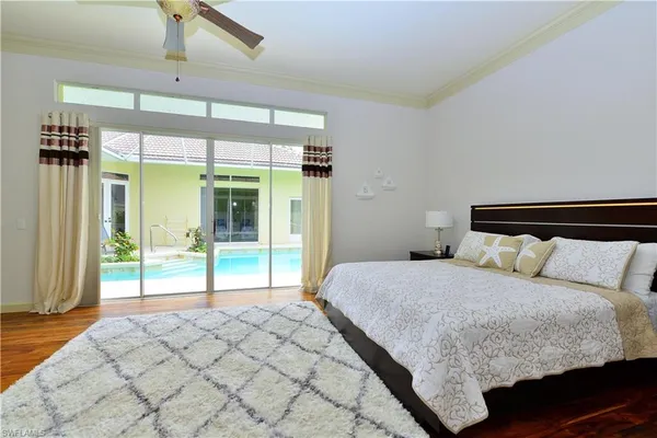 a bedroom with a large bed and a large window