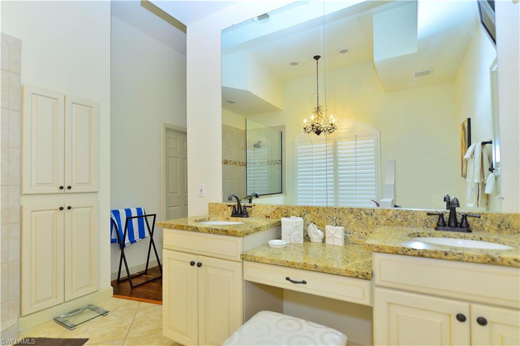 634 Soliel Drive Naples, FL 34110 - Photo 13 of 17 a bathroom with a granite countertop sink and a mirror