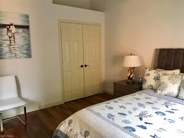 a bedroom with a bed and a chair