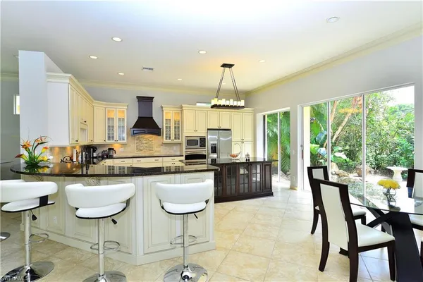 a kitchen with counter top space appliances and furniture