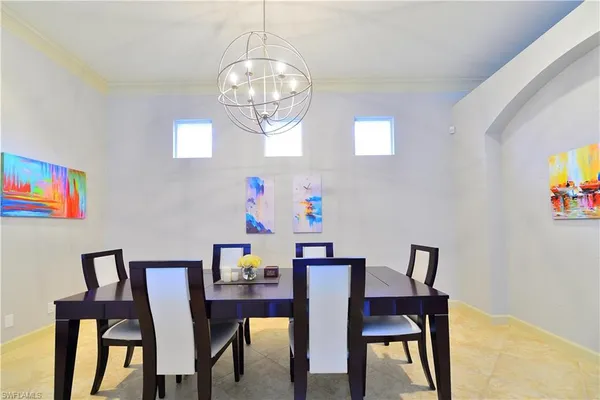 a view of a dining room with furniture and chandelier