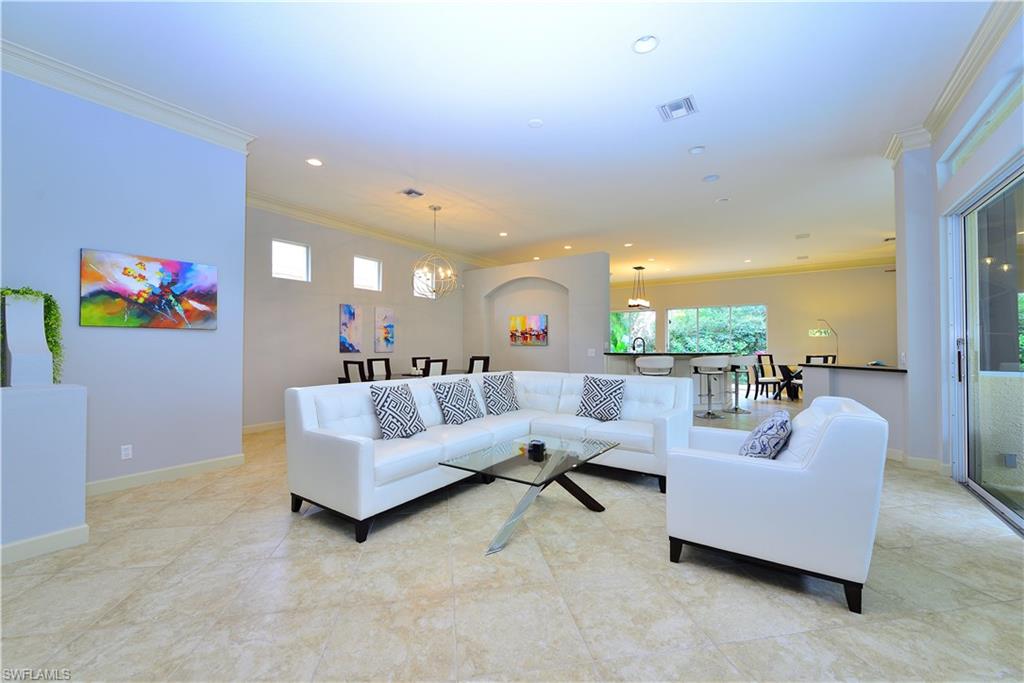 634 Soliel Drive Naples, FL 34110 - Photo 6 of 17 a living room with furniture and a large window