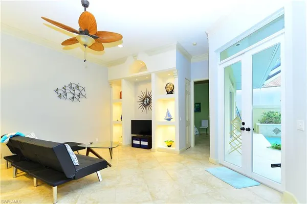 a living room with furniture and a chandelier