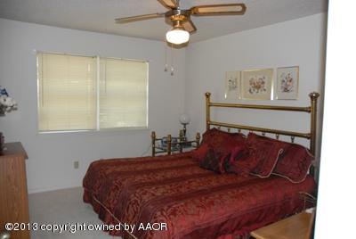 8207 Goodnight Trail Amarillo, TX 79110 - Photo 11 of 16 a bedroom with a bed and a window