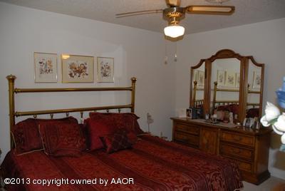 8207 Goodnight Trail Amarillo, TX 79110 - Photo 12 of 16 a bedroom with a bed and window