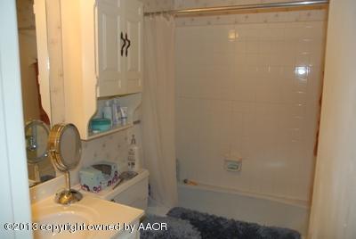 8207 Goodnight Trail Amarillo, TX 79110 - Photo 13 of 16 a bathroom with a sink and a mirror