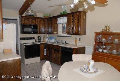 8207 Goodnight Trail Amarillo, TX 79110 - Photo 5 of 16 a kitchen with a sink stove and microwave