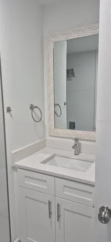 a white toilet sitting next to a bath tub and a shower