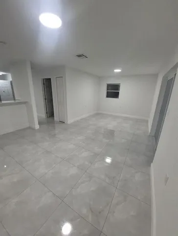 a kitchen with cabinets and a refrigerator