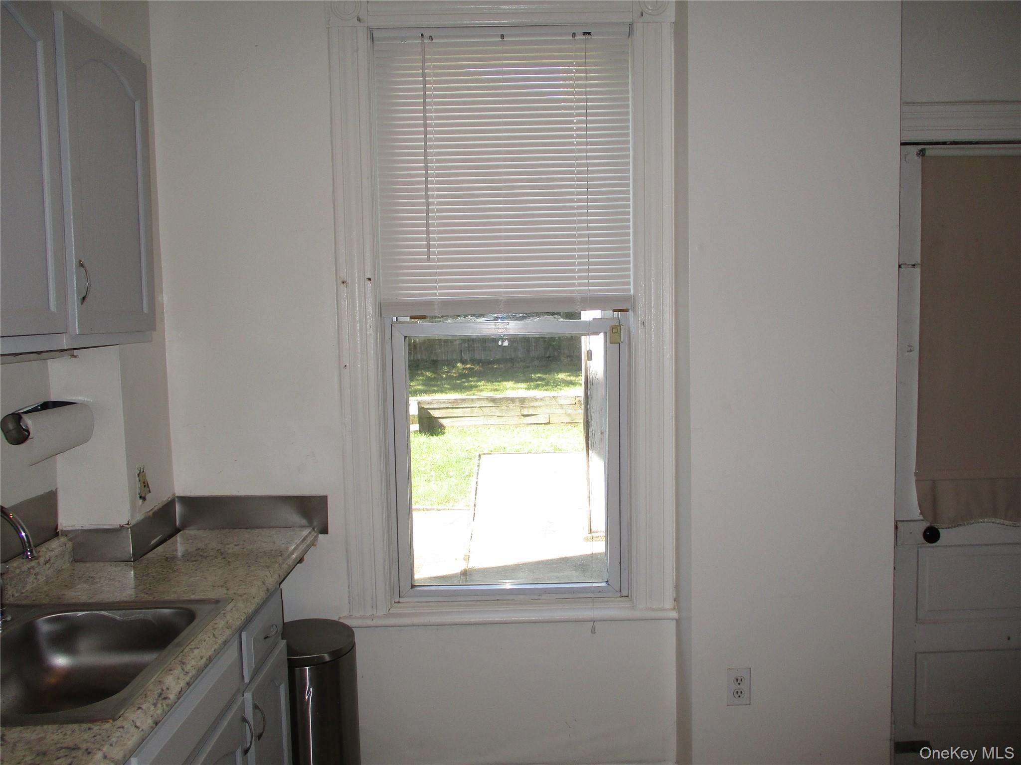33 Bayview Terrace, Unit 1 Newburgh, NY 12550 - Photo 11 of 20 Kitchen with gray cabinets and a sink
