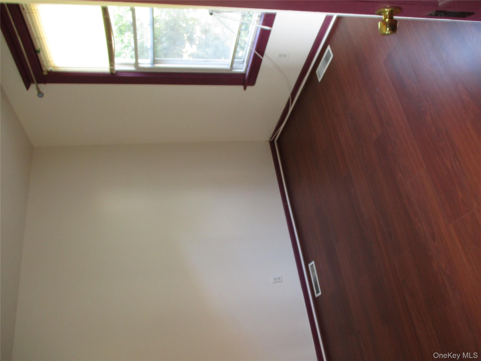 33 Bayview Terrace, Unit 1 Newburgh, NY 12550 - Photo 20 of 20 Empty room featuring dark wood finished floors and baseboards
