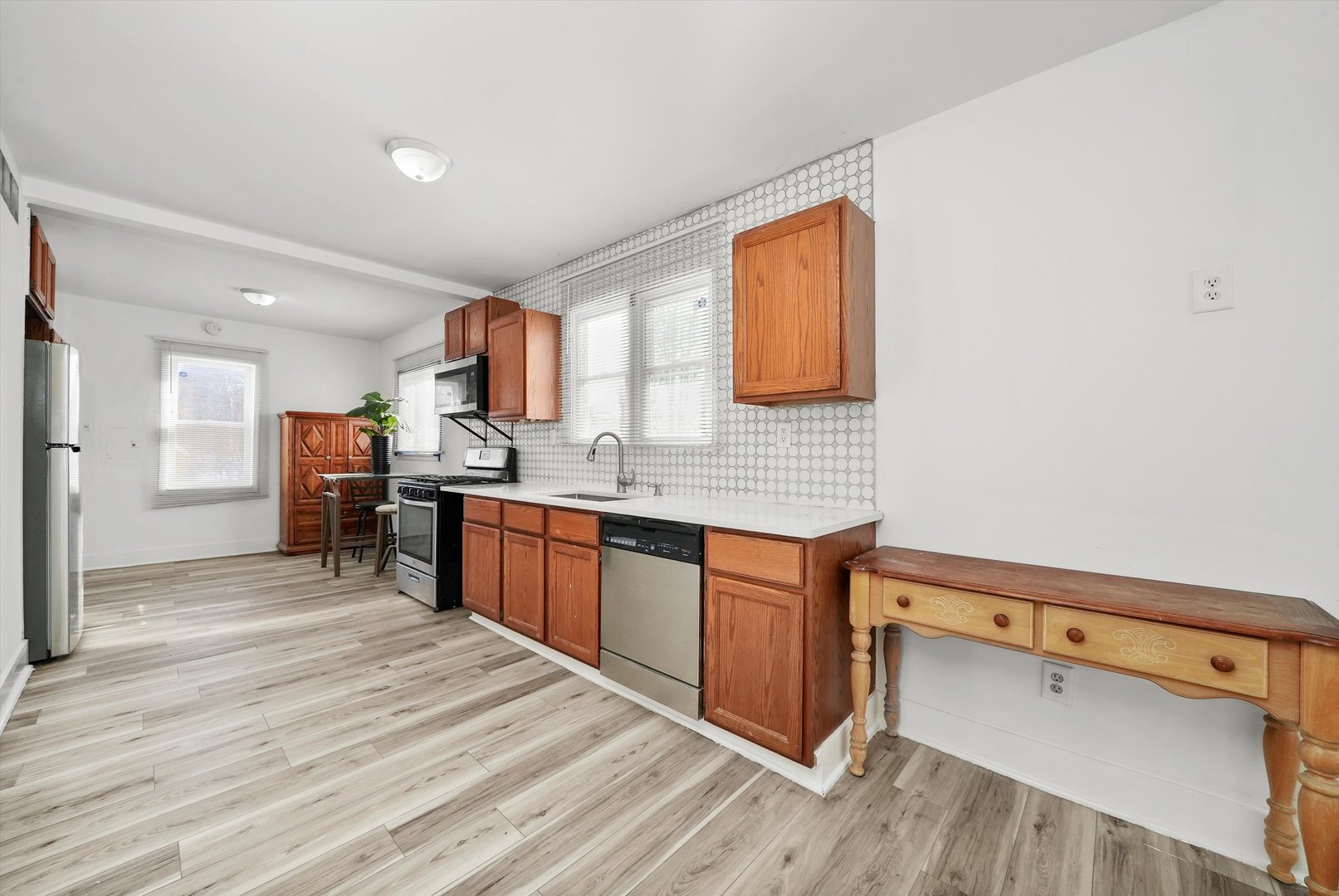 14525 Justine Street Harvey, IL 60426 - Photo 13 of 32 a kitchen with a sink cabinets and wooden floor