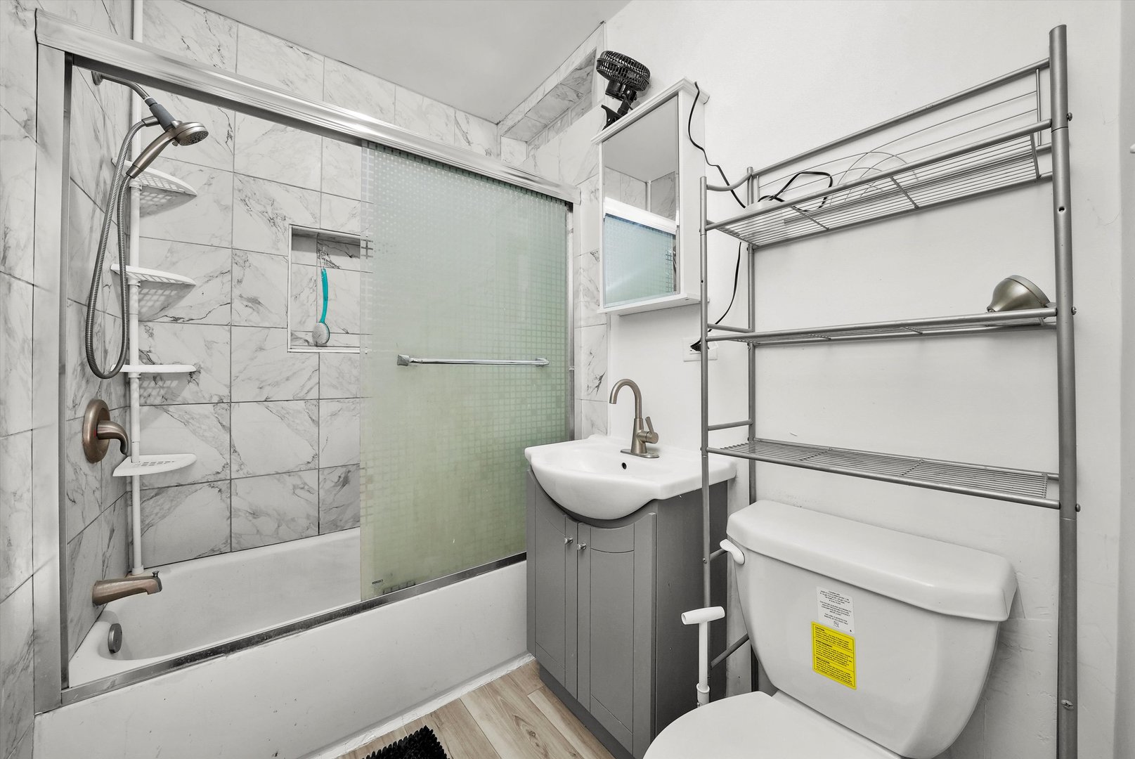 14525 Justine Street Harvey, IL 60426 - Photo 27 of 32 a bathroom with a sink toilet and shower