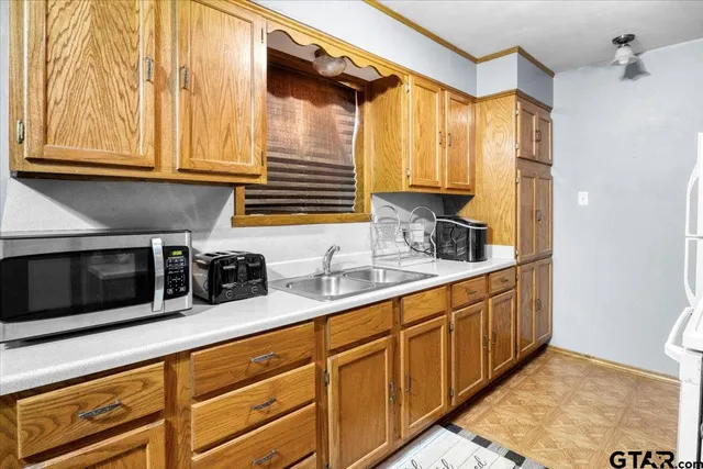 a kitchen with stainless steel appliances a sink and a microwave