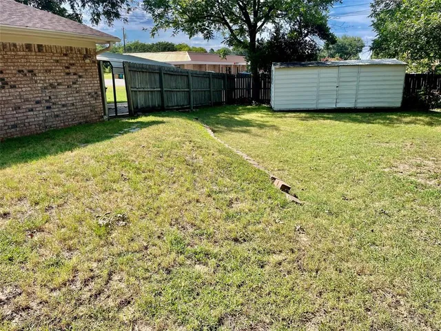 a view of a backyard with a large tree