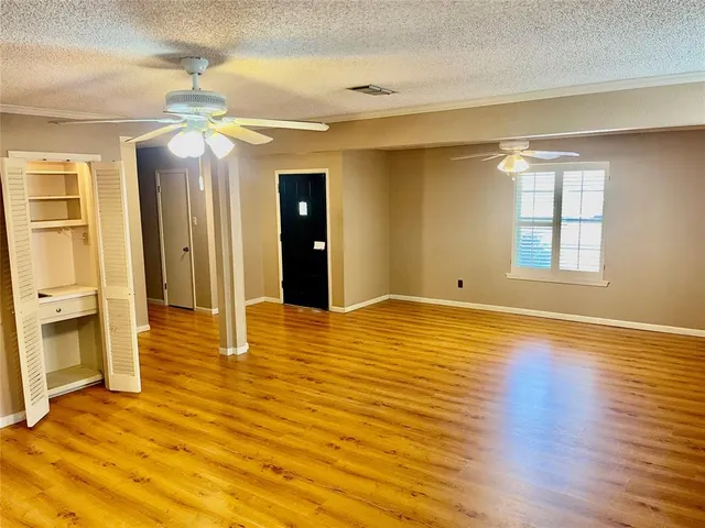 a view of a room with wooden floor and natural light