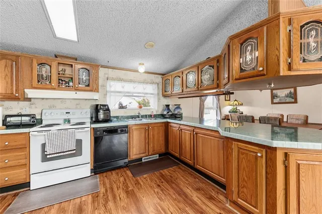 a kitchen with stainless steel appliances granite countertop a stove and cabinets