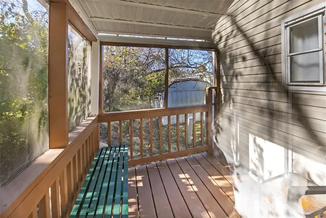 a view of a balcony with wooden floor